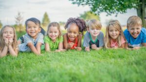 kids smiling in the grass